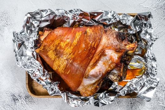 Roast pork knuckle with pepper and spices. Gray background. Top view.