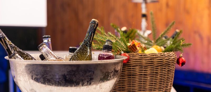 Wine bottles set in bucket, alcohol cooling