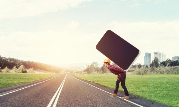 Man engineer carrying on back big smartphone