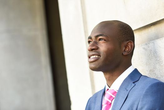 Portrait of handsome black man wearing suit in urban background