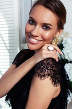 young pretty lady in black lace fashion style dress posing in rich interior of royal hotel room, luxury lifestyle people concept closeup