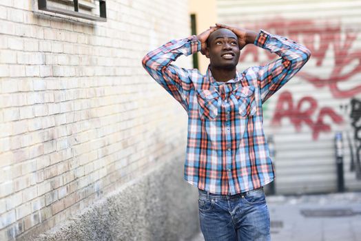Portrait of black man very happy, smiling in urban background