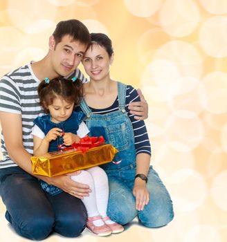 Happy young family with little daughter cuddling together in celebration of Christmas.Brown festive, Christmas background with white snowflakes, circles.