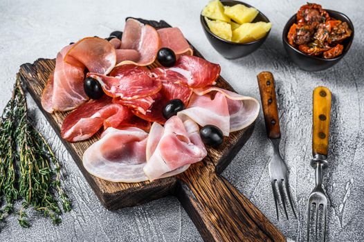 Cured meat platter of traditional Spanish tapas. White background. Top view.