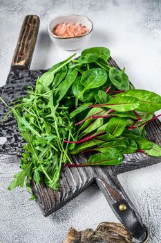 Fresh mixed greens, spinach, swiss chard and arugula. White background. Top view.