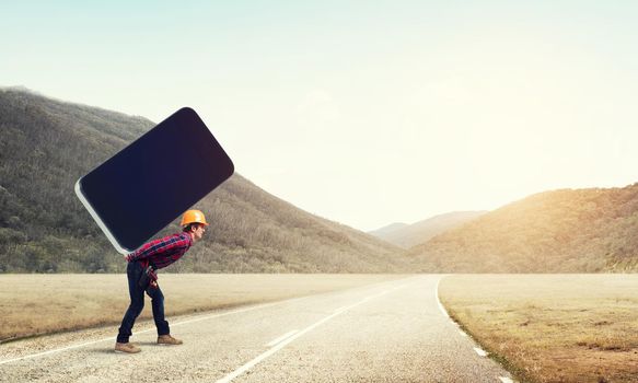Man engineer carrying on back big smartphone