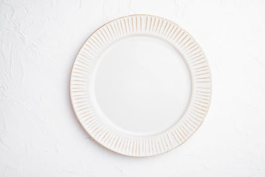 White plate empty utensil set with copy space for text or food with copy space for text or food, top view flat lay, on white stone table background