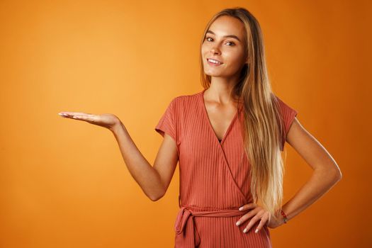 Portrait charming pretty cheerful girl showing copy space close up