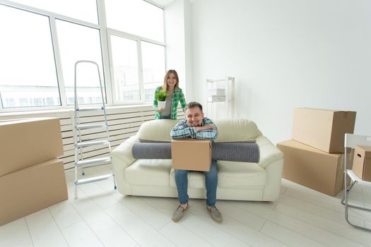 Young cheerful couple moving into their new home.