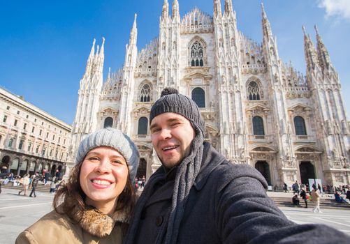 Couple taking self portrait in Duomo square. Concept about traveling and relationship