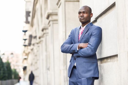 Portrait of handsome black man wearing suit in urban background