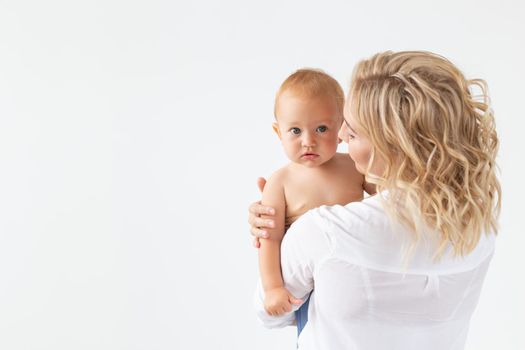 Childhood, motherhood and family concept - Portrait happy mother holds her baby.