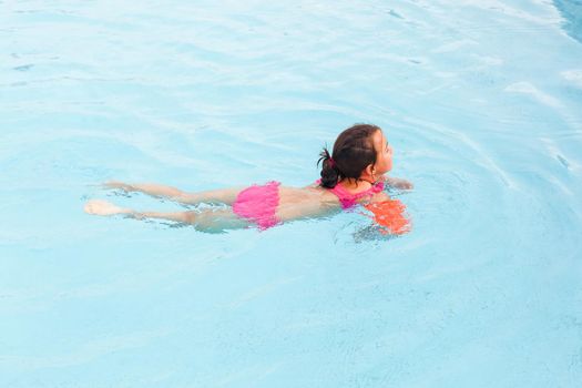 happy girl in the swimming in swimming suit.