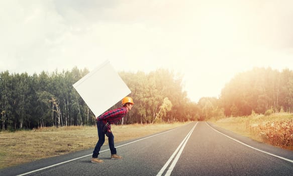 Man carrying on his back large box