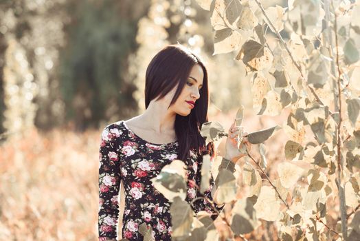 Portrait of pretty girl with green eyes wearing casual clothes in an autumn field