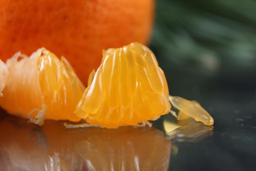 slice a piece of tangerine close-up. Orange citrus with white veins. food close-up.