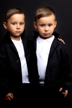 two little boys dressed in tuxedo. Isolated on white background