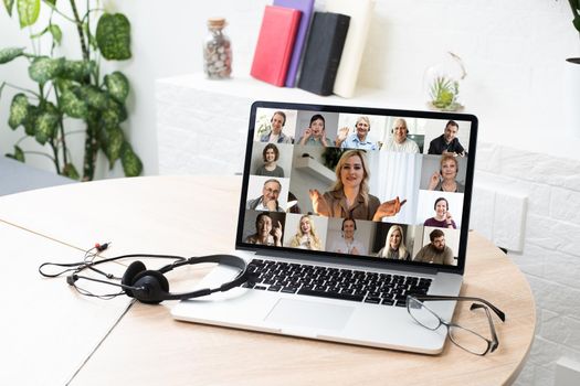 Many portraits faces of diverse young and aged people webcam view, while engaged in videoconference on-line meeting lead by businessman leader. Group video call application easy usage concept.