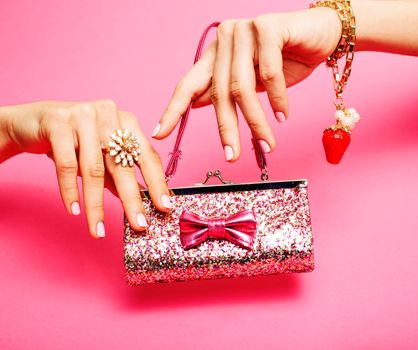 little girl stuff for princess, woman hands holding small cute handbag with jewelry and manicure, luxury lifestyle concept close up