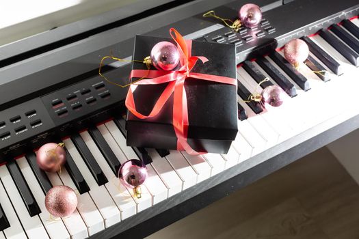 Christmas gift box on a piano keyboard, above view