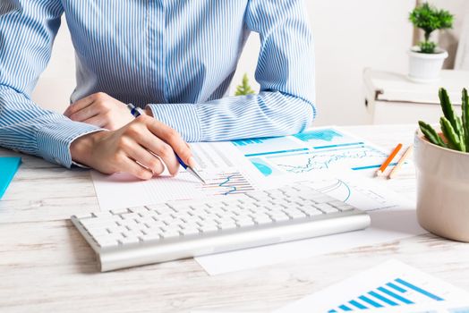 Business consultant sitting at desk and analyze financial report. Strategy planning and investment. Corporate office workplace with analyst at wooden desk. Business accounting and management.