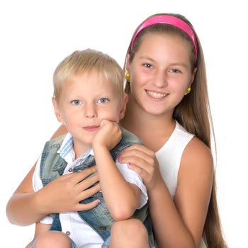 A teenage girl with her younger brother. studio photo session. The concept of family happiness.Isolated on white background.