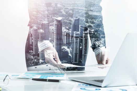 Businesswoman standing near office desk with laptop and documents. Financial audit and consulting. Corporate manager in suit working with online business analytics. Investment and stock trading.
