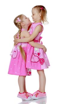 Two cute little girls in full growth, in the studio on a white background. The concept of a happy childhood, Beauty and fashion. Isolated.
