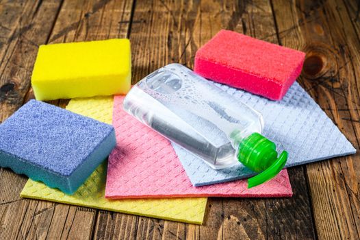 Washing and cleaning stuff, domestic supplies for spring cleaning service. wooden background. Top view.