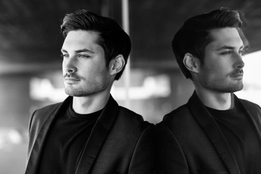 Portrait of an attractive man, model of fashion, wearing modern suit.