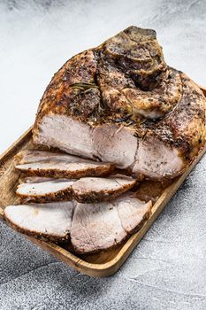 Roasted sliced pork ham. Shank meat. Gray background. Top view.