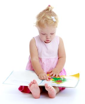 A little girl with an open book in the Studio