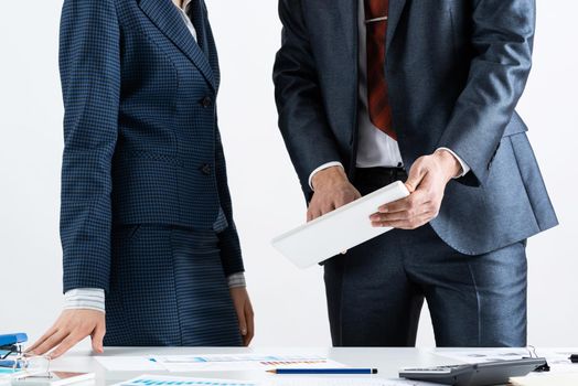 Corporate teamwork concept with business people. Office desk with financial charts. Business meeting time in conference hall. Presentation and discussion of new startup project. Business partnership