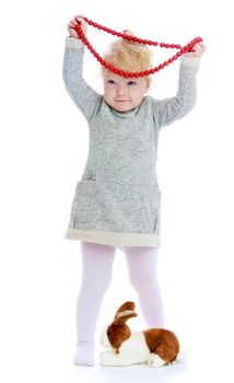 Cheerful little girl with a big red underpants on his head. Isolated on white background .