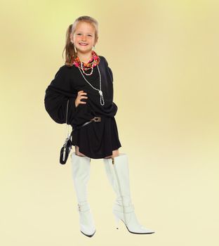 Fashionable little girl in big white boots.the concept of fashion.