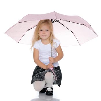 A nice little girl hid under an umbrella. The concept of a happy childhood, outdoor recreation, protection from bad weather. Isolated on white background.