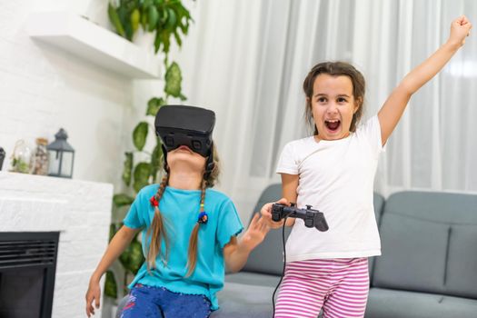 two little girls using glasses of virtual reality headset. concept of modern technologies