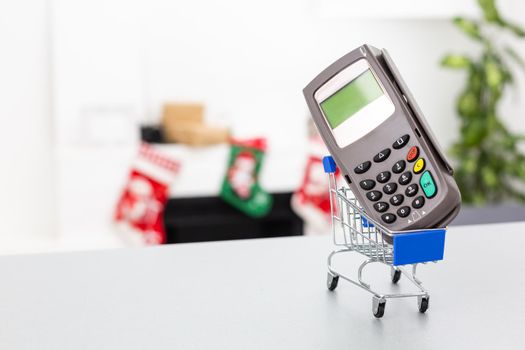 Top view photo of shopping trolley and cash register