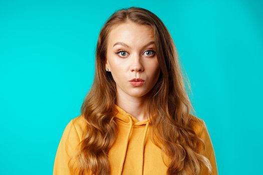 Shocked and amazed young woman with funny face expression close up