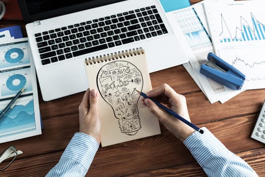 close-up, woman draws business notes in her notebook. Business Innovation Concept