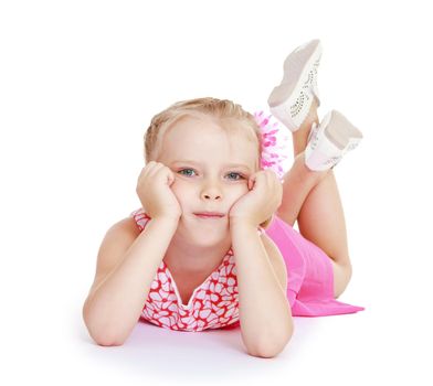 Little girl lying on the floor with his legs crossed. Isolated on white background .