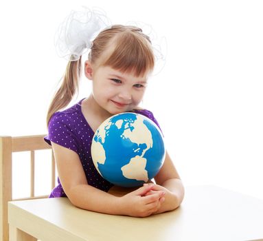 Happy childhood, adolescence, the development of the family concept. Little girl examines the globe isolated on white background.