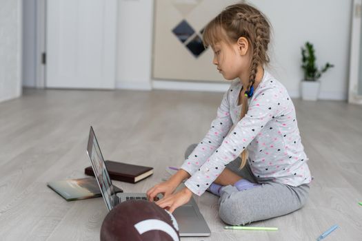 Little girl Hands using laptop. Online shopping in childhood.