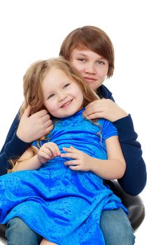 Big brother teen holds the hands of his beloved younger sister.Isolated on white background.