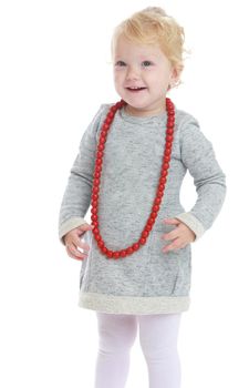 Very fashionable little girl in red beads. Isolated on white background .