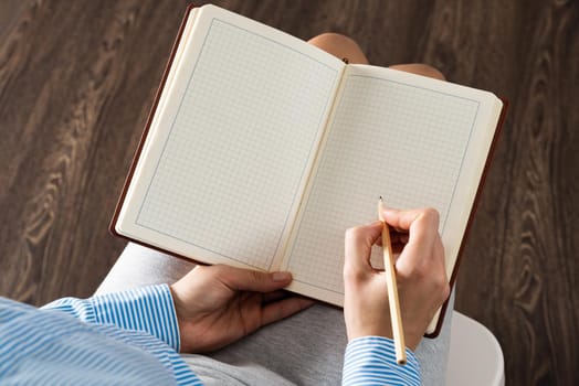 close-up a female hands with notebook and pencil