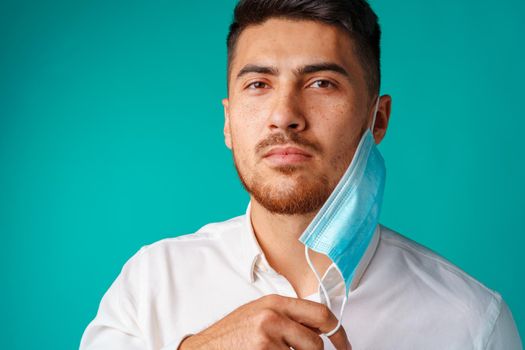 Handsome mixed-race man wearing medical face mask close up