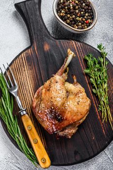 Fried duck confit leg baked poultry meat. White background. top view.