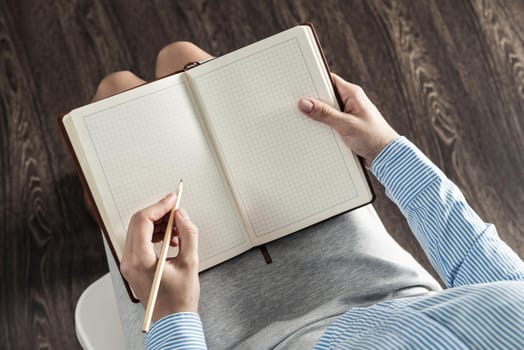 close-up a female hands with notebook and pencil