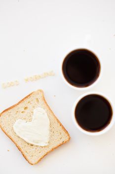 sandwich for breakfast in the form of heart with cheese - good morning sign and two coffee cups